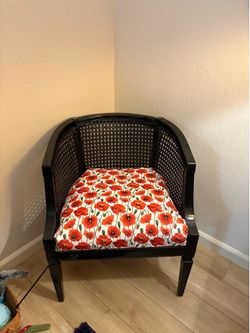 Black chairs and ottoman with red poppy upholstery