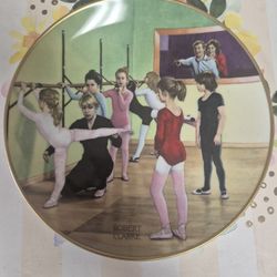 decorative collector plate titled "At The Barre" featuring artwork signed by Robert Clarke. 