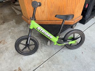 Green 12” Strider balance bike