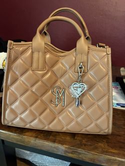 New Purse . Brand New. Still Has Protective Plastic On Charm 