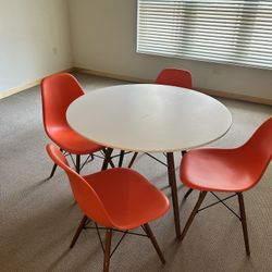 White Wood Circular Table With 4 Orange Chairs