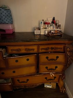 Wood dresser with detailing and marble counter