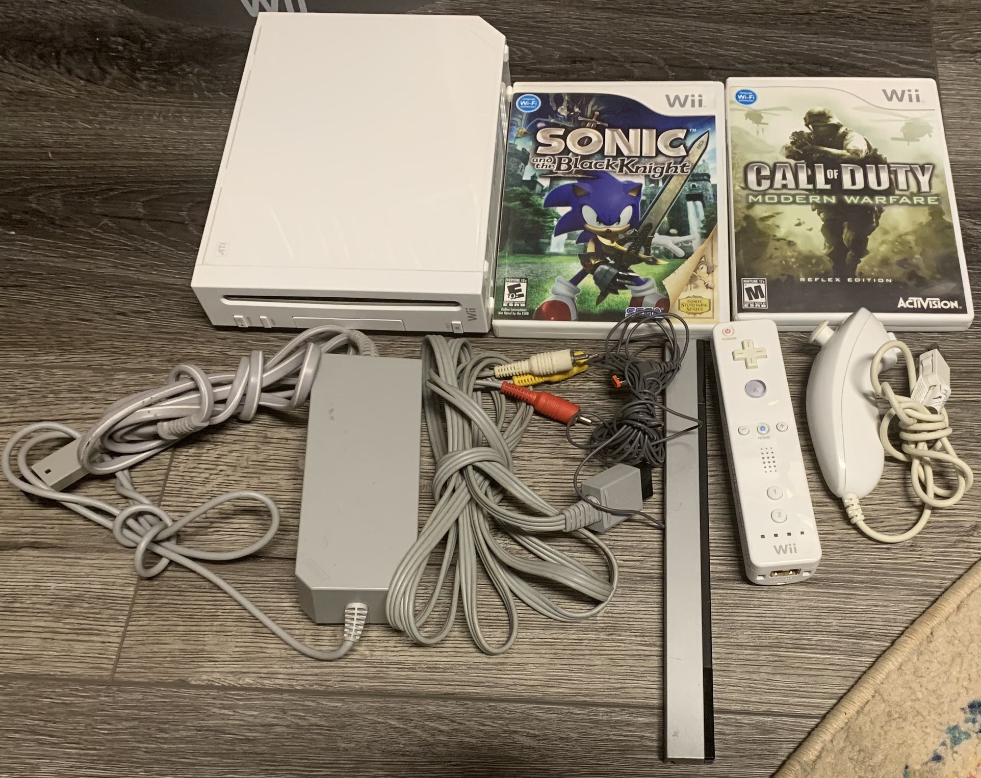Nintendo Wii System with 2 games, 1 controller, 1 nunchuk and cables