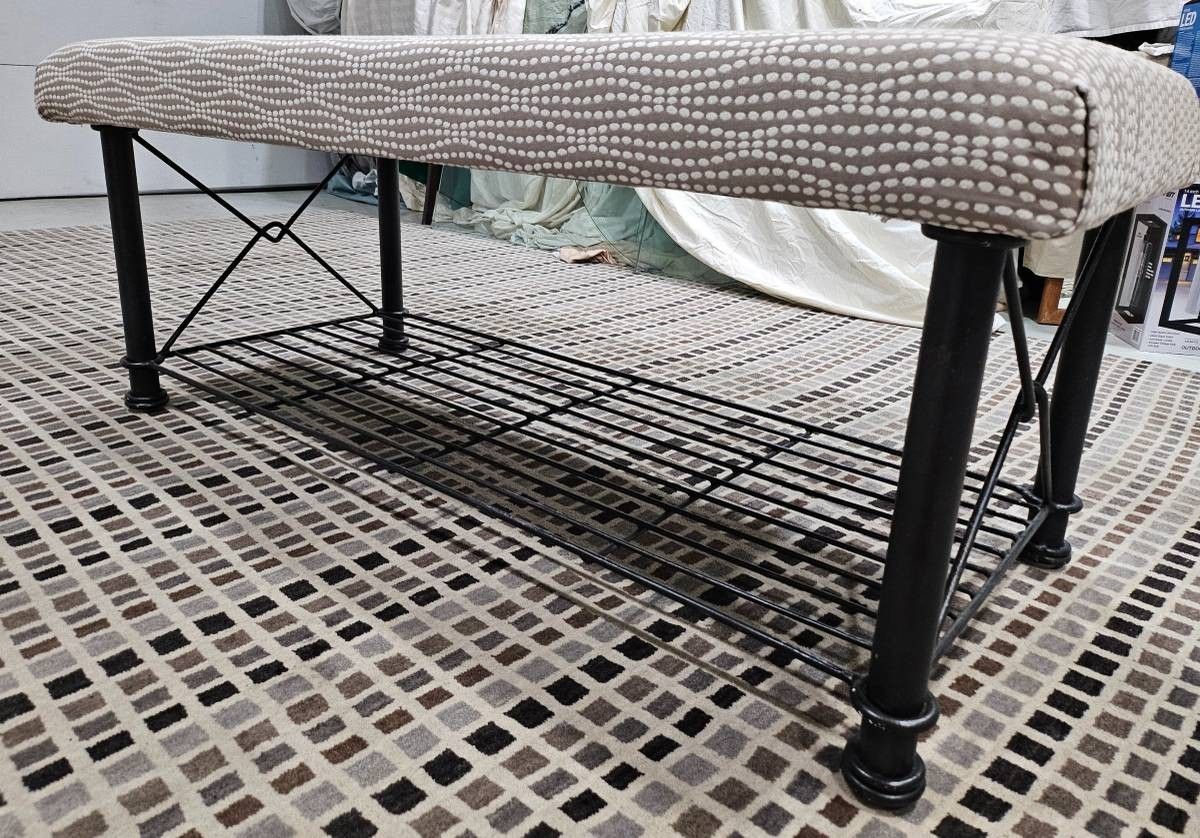 Sturdy Indoor/ Outdoor Bench With Black Iron Base And Tan And Cream Color Fabric.