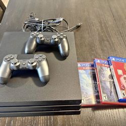 PlayStation 4 PRO 1TB with 2 controllers and 3 games.