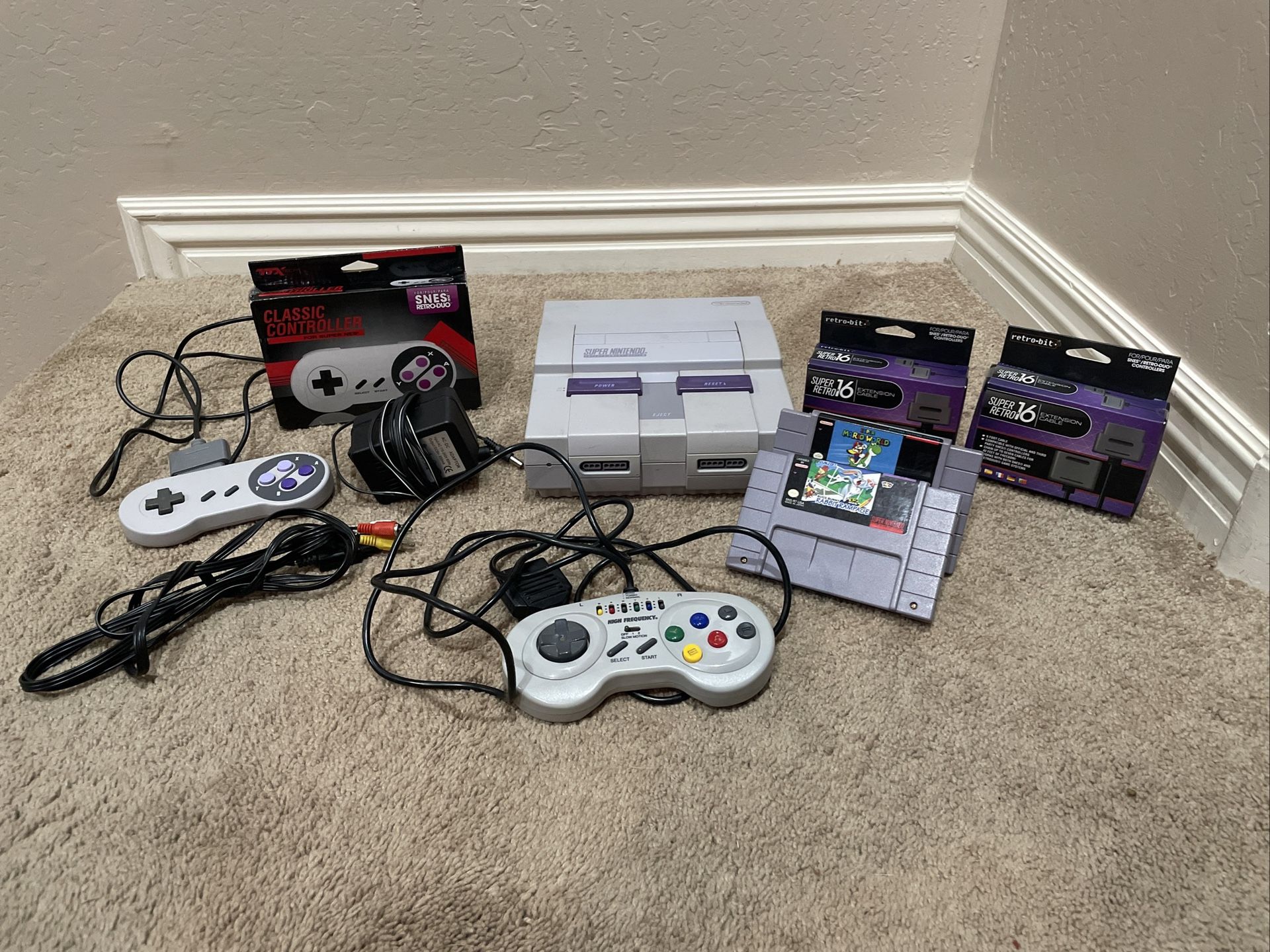 Super Nintendo SNES system console that comes with 3 controllers (1 is a High Frequency controller) 2 Extension cables for controllers and 2 games.  