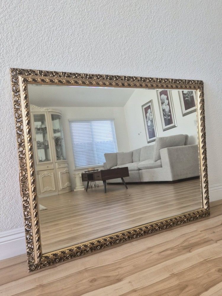 Gold ornate hanging mirror