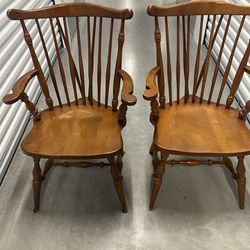 Two Very Vintage Nutmeg Maple Brace Back  Arm Chairs In Good Condition. Used in good condition with some cosmetic blemishes. These blemishes are in th