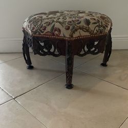 Tapestry Covered Ottoman with Decorative Brass Tacks & Carved Wooden Base & Legs Approx. 22” Across x 14” High