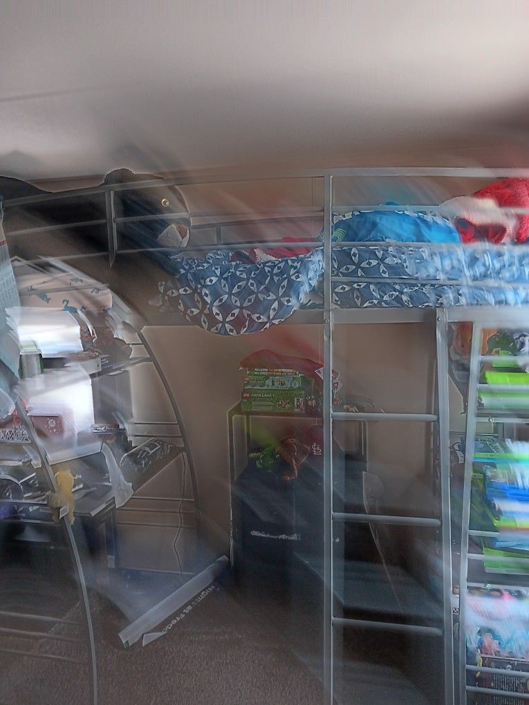 Loft Bed With Shelving And A Desk Underneath 