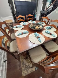 Dining room table with 8 chairs. Centerpiece, placemats and rug included included