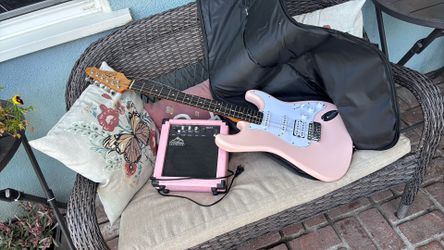 East rock, pink guitar, and guitar amplifier and bag to go with it