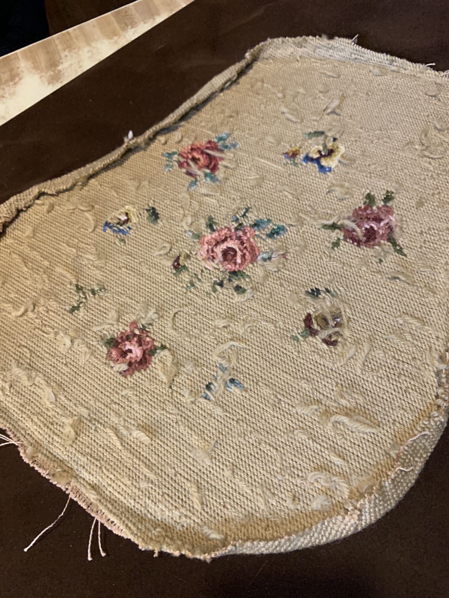 Antique floral needlepoint Roses and Pansies on a khachi/tan background. Formally a small slipper chair seat covering. Circa 1910-20