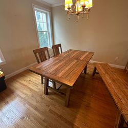 Wooden dining table with two chairs and a bench 