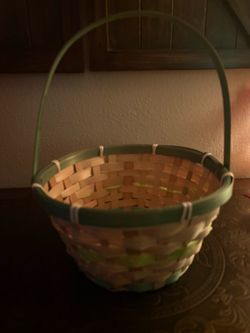 two-tone woven bamboo basket featuring a natural beige body accented with green trim