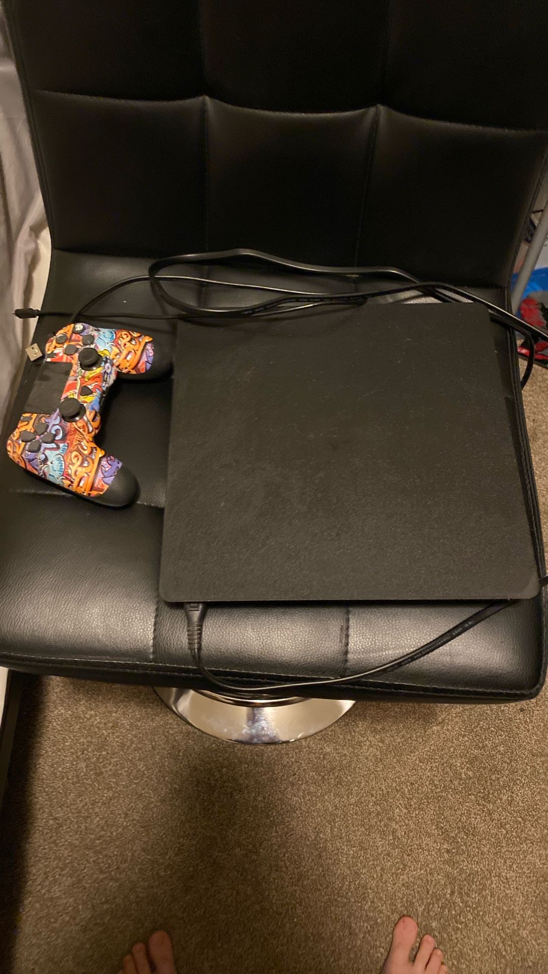 PS4 With A Controller And The Charger