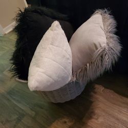 Two Faux Fur Decorative Pillows, One Rectangular Decorative Pillow, And Round Faux Wicker Basket