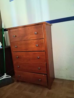 Traditional cherry-finish 5-drawer wooden tall chest featuring round metal pull knobs.