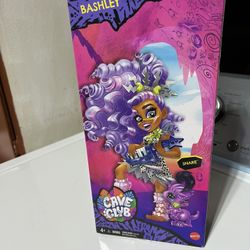 Mattel Cave Club Bashley Doll (8-10-inch, Lavender Hair) Poseable Prehistoric Fashion Doll with Dinosaur Pet and Accessories, Gift for 4 Year Olds and