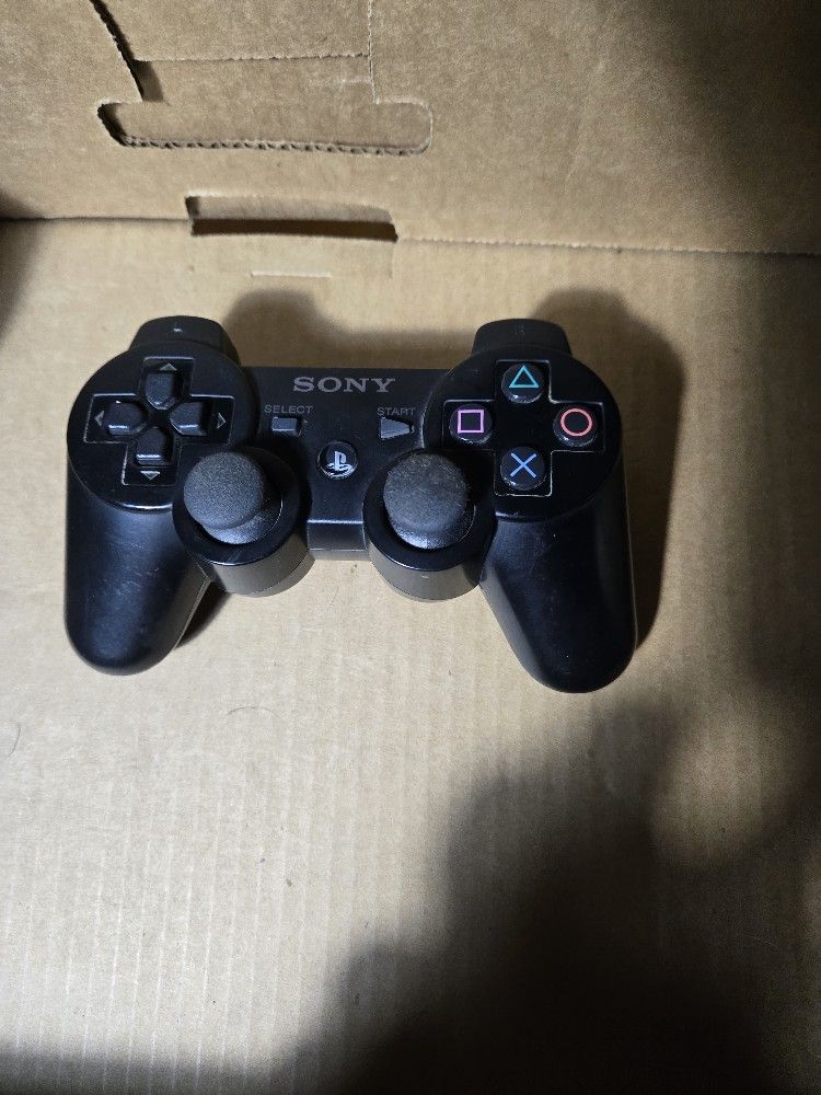 Black Sony PlayStation DualShock 3 Sixaxis controller.