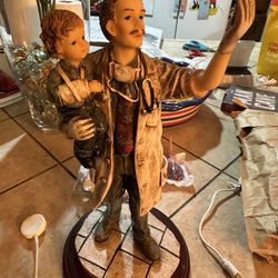 Beautiful Doctor statue holding a baby