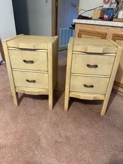 A pair of cream colored 2 drawer nightstands