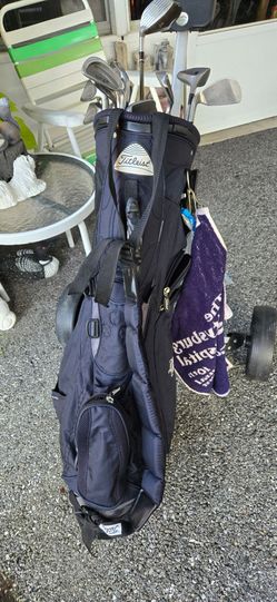 Golf bags with clubs + balls and  bag cart