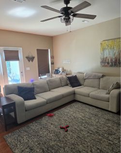 Large Gray Fabric Sectional Sofa. $500. Will deliver for a fee.