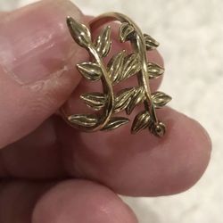 Gold plated over .925 silver ring.   Beautiful leaves around your finger, and is adjustable. 
