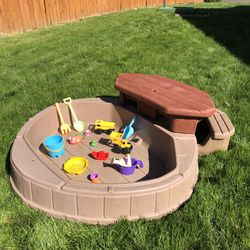 Sandbox with picnic table and toys 