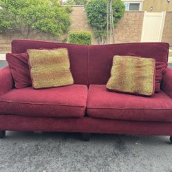 Red Couch With Four Pillows 