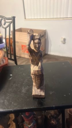 This is a vintage hand-carved wooden folk art sculpture depicting a musician playing a conga-style drum.