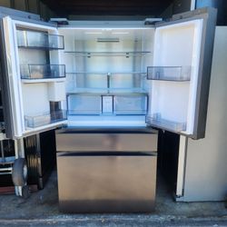 A Samsung 4-door refrigerator has a screen that is 36 inches wide by 68.5 inches high and 29 inches deep.