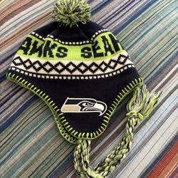 Seahawks Knit Beanie With Braided Tassels And Pom Pom On Top.  Keeps ears warm