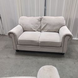 Textured Beige Fabric Loveseat with Nailhead Trim