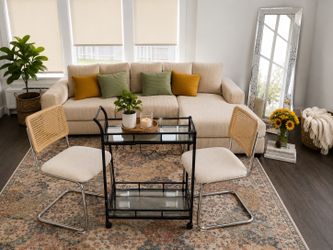 L shaped couch, mirror, rug, bar stool, and bar cart