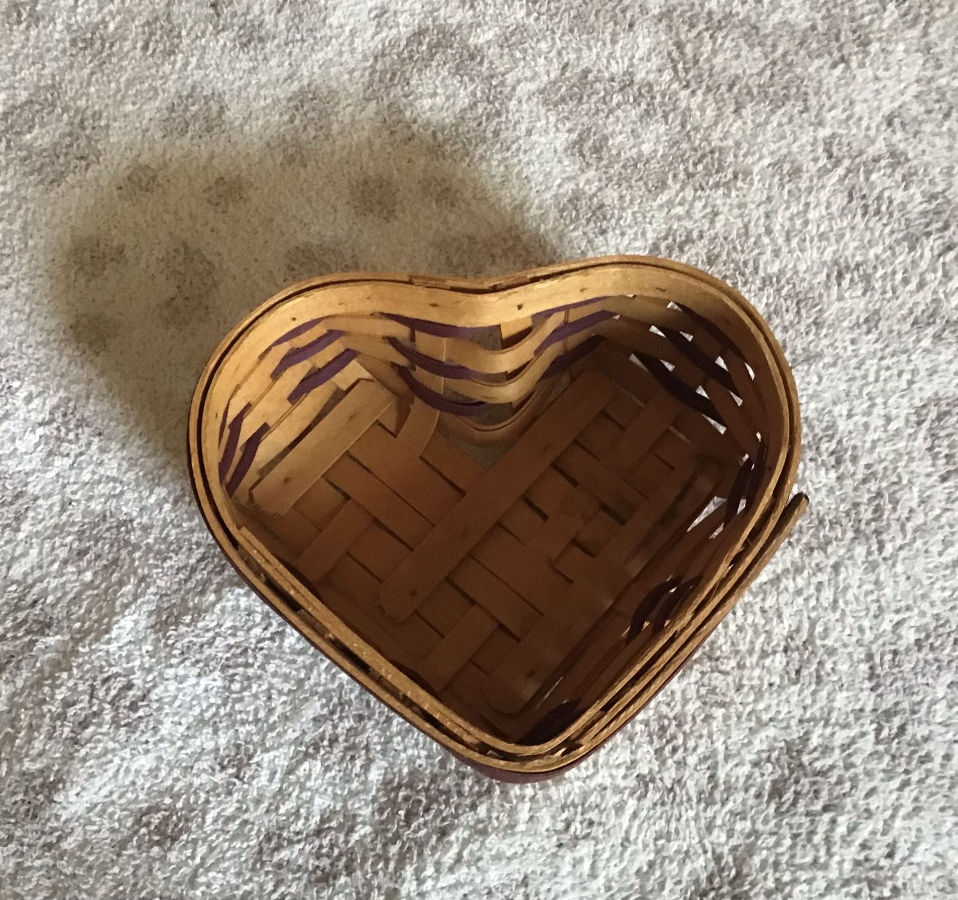 Longaberger 2000 Century Celebration heart shaped basket 6.25 inches long, 5.25 inches wide, and 2.5 inches tall. The top part of the lid is worn and