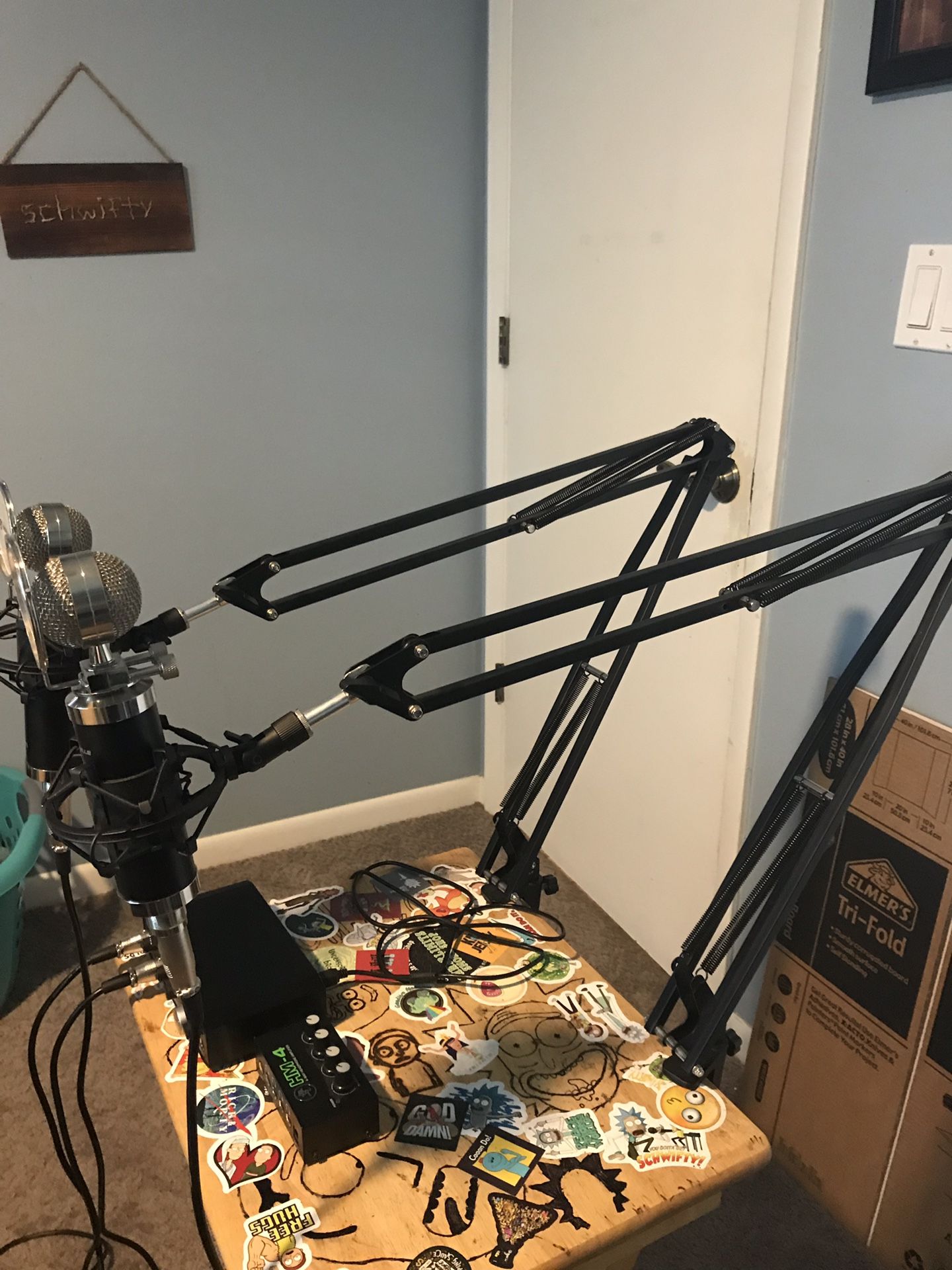 Complete podcast setup: microphones, arms, amp, driver, headphones, and laptop cooling station