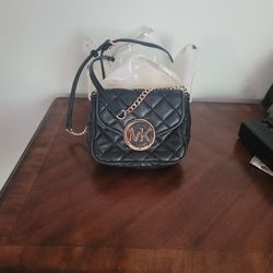 Black Quilted Leather Crossbody Bag with Gold MK Logo.