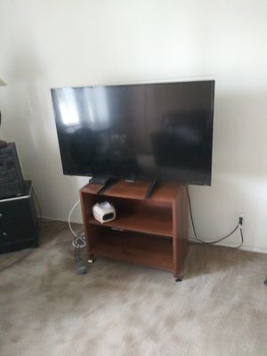 Photo Roku smart 44 inch television with wood stand for free