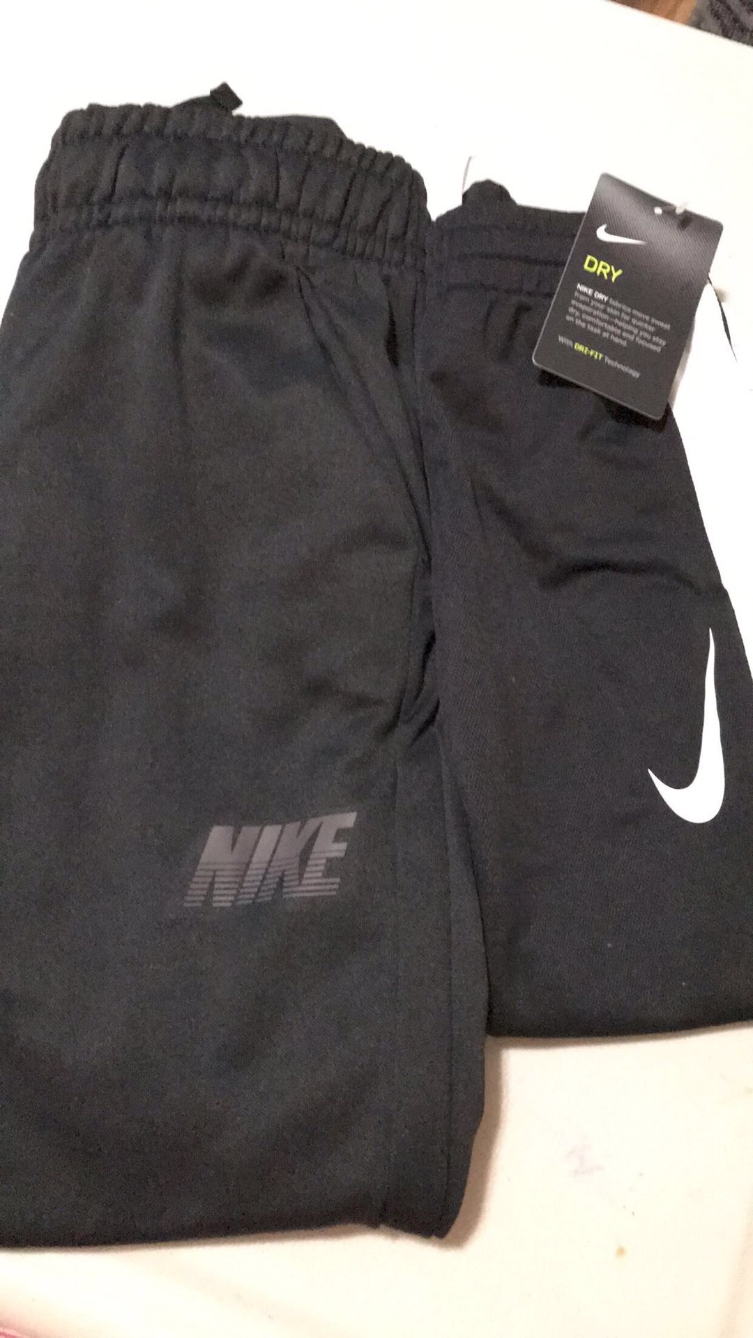 Nike pants brand new one size 4 the other 7?