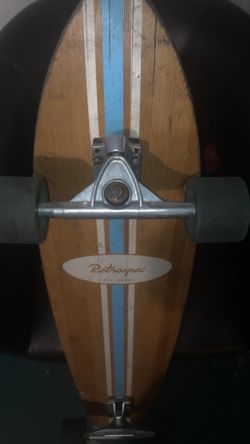 This is a Retrospec Zed 44" bamboo longboard with a blue and white striped design.