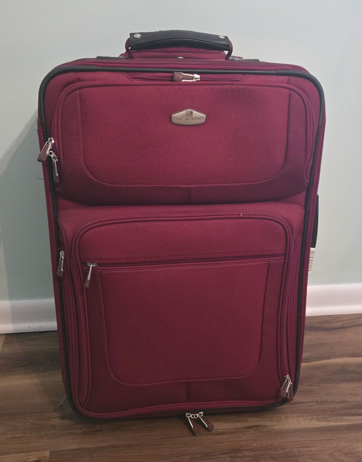 Ricardo burgundy travel suitcase