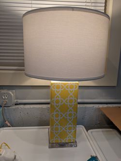 Lamp. Beautiful bright light with white shade and beautiful yellow design. Yellow light