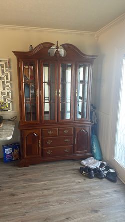 wooden cabinet with glass doors and drawers