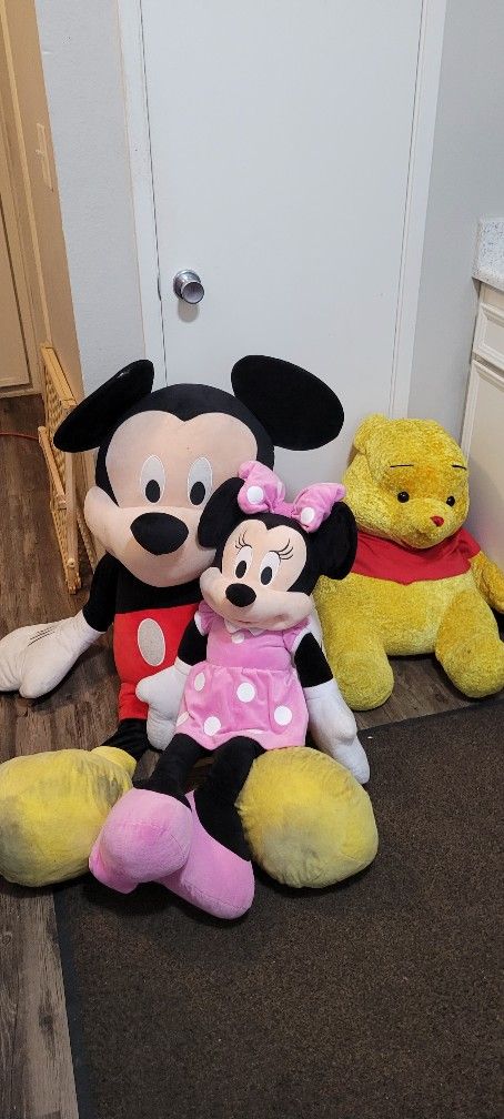 Mickey Mouse and Minnie Mouse and Winnie the Pooh stuffed animals