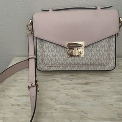 Great slightly used Michael Kors cross body pink purse with pink