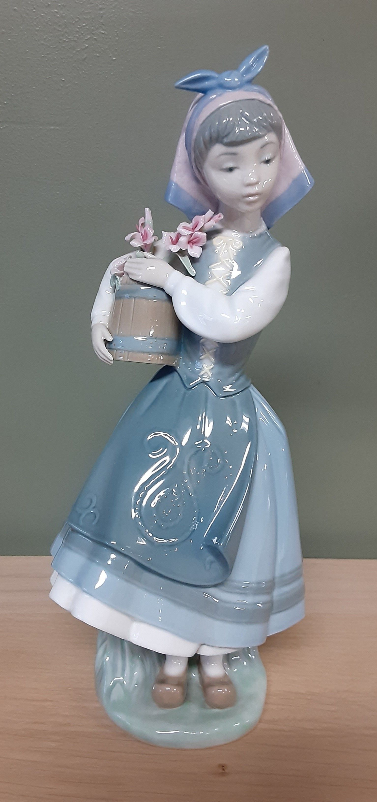 Lladro girl with flower basket.