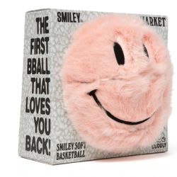 MARKET Smiley Fur Basketball in pink. It is a plush, decorative item created in collaboration with the Smiley brand