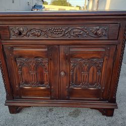 ANTIQUE SOLID CARVED WOOD BUFFET CABINET WITH ARCH AND GRAPE DETAIL